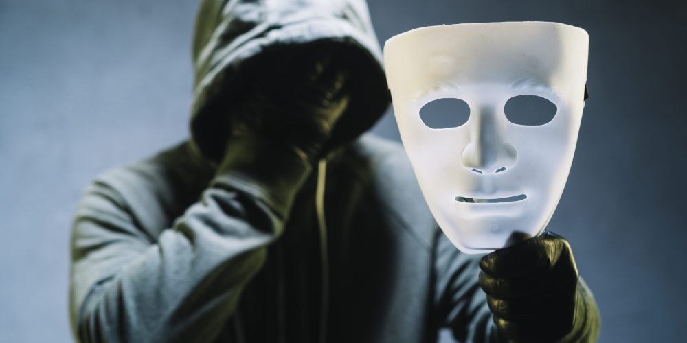 hacker-holding-mask