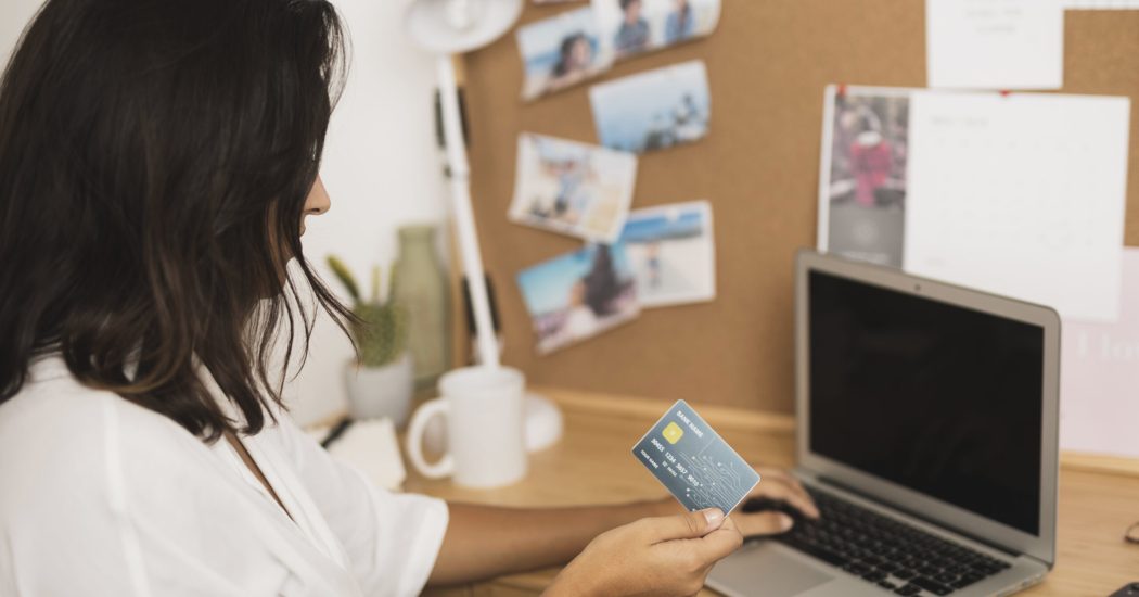 woman-holding-card-working-laptop-mock-up